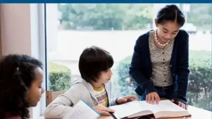 teacher helping students read