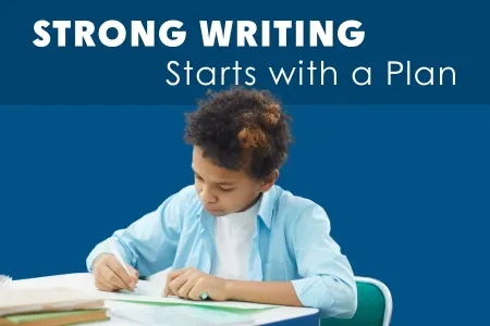 student writing at a desk